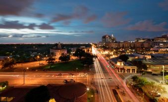 a busy city street at night , with numerous cars and trucks traveling down the road at Aloft Coral Gables