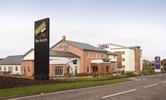 "a large hotel building with a sign that reads "" golden inn "" prominently displayed on the front of the building" at Premier Inn Burgess Hill
