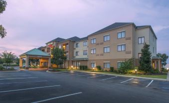 a large hotel building with multiple windows and a parking lot in front of it at Courtyard by Marriott Montgomery Prattville
