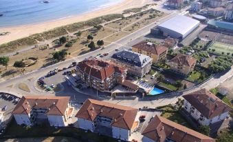a bird 's eye view of a beachfront resort with several buildings and a swimming pool at Hotel Gala