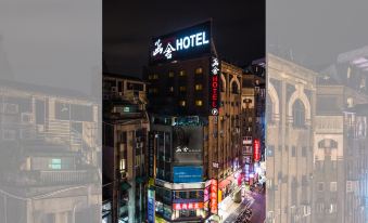 a nighttime view of the shanghai world financial center , a famous landmark in shanghai , with its illuminated sign and various buildings lit up at Han She Business Hotel