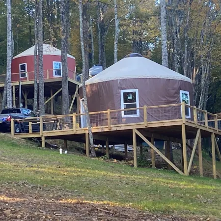 Elevated eclectic yurt with wrap-around porch, hot tub, and mountain view!