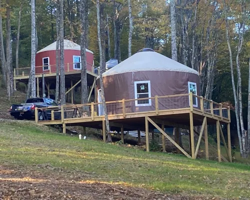 Elevated eclectic yurt with wrap-around porch, hot tub, and mountain view! Hotels in Piper Gap