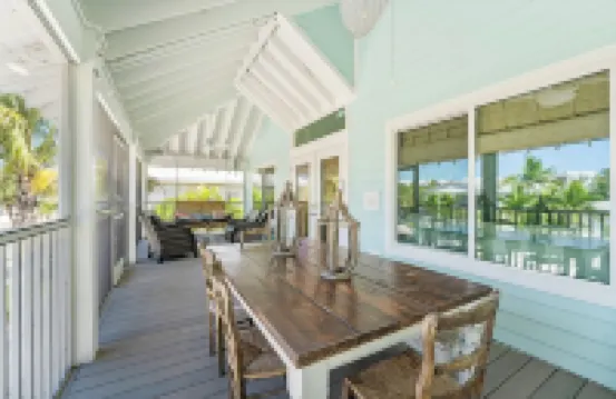 Charming cottage with heated pool, tropical landscaping in prime location.
