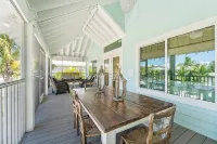 Charming cottage with heated pool, tropical landscaping in prime location.