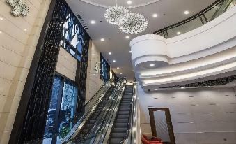 The upscale building features a large staircase and chandelier in the lobby on each floor at Rosedale Hotel Hong Kong