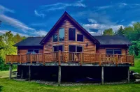 Experience the rustic charm of a log cabin chalet nestled on 14 private acres.