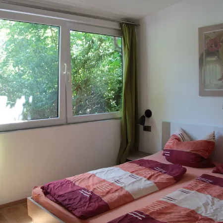 Modernly Furnished Bungalow with Fireplace, Surrounded by Greenery.