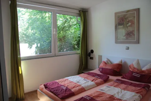 Modernly Furnished Bungalow with Fireplace, Surrounded by Greenery.