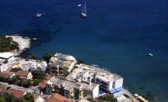 an aerial view of a coastal town with boats in the water and buildings surrounding it at Argo Spa Hotel