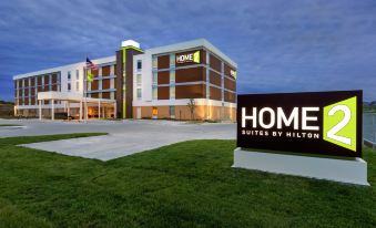 "a large , modern hotel building with a sign that reads "" home suites by hilton "" in front" at Home2 Suites by Hilton Omaha/West
