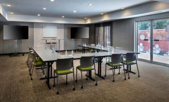 a conference room set up for a meeting , with chairs arranged in a semicircle around a table at SpringHill Suites Herndon Reston