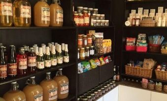 a well - stocked pantry filled with various food items , including spices , jams , and other preserves , on shelves at Town's Inn