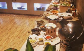 a buffet table filled with a variety of food items , including fruits , vegetables , and meats at Royal View Hotel