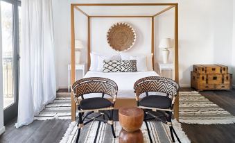 a cozy bedroom with two beds , one on the left and one on the right side of the room at Grecotel Plaza Beach House