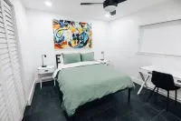 Luxurious modern home w/ private tropical backyard close to beach and downtown!