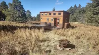 Tiny house on the prairie with mountain views.