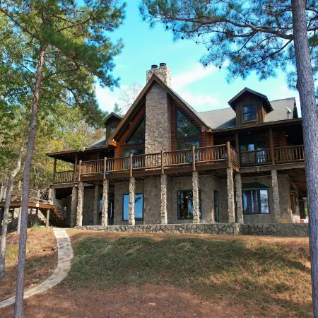 Large six-bedroom loghome w/ private boat ramp, dock, movie room and pool room.