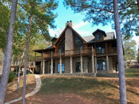 Large six-bedroom loghome w/ private boat ramp, dock, movie room and pool room.