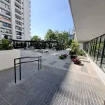 In front of Hospital U. de Chile with parking lot.