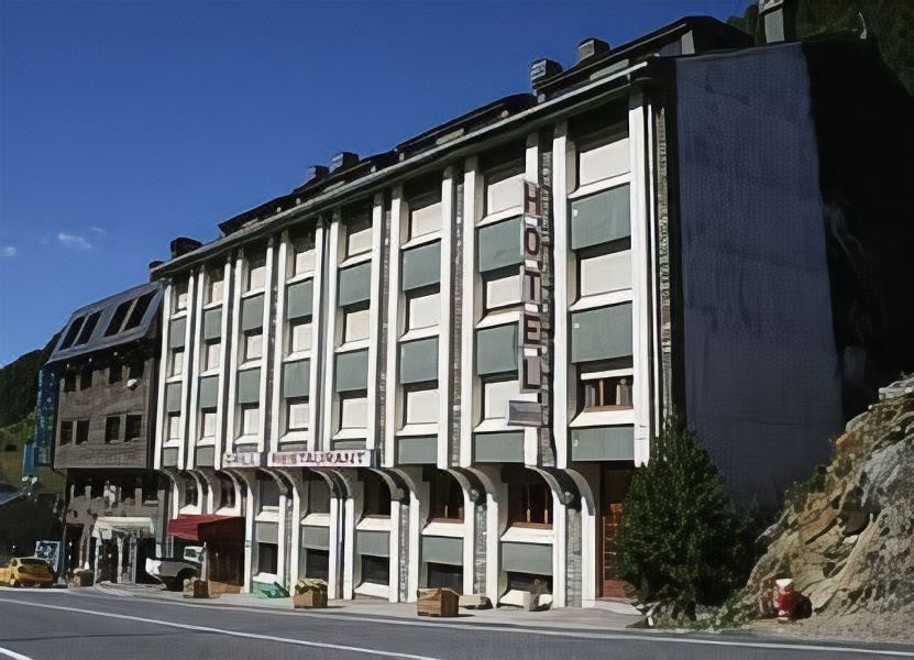 "a building with a large sign that says "" hotel "" in red letters is situated on a street" at Hotel Austria