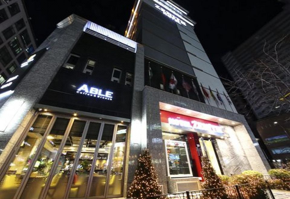 A time-lapse photo was taken from outside a building showing lights on in front at night at Hotel Zenith