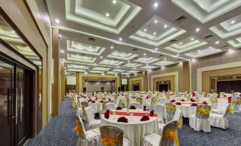 a large banquet hall with tables and chairs set up for a formal event , possibly a wedding reception at Pematang Siantar