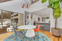 Luxurious midcentury modern glass house in the woods, chefs kitchen & great art