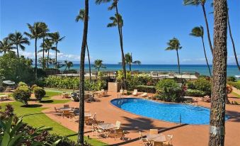 a beautiful resort with a swimming pool surrounded by palm trees and a view of the ocean at Van Winkle Inn