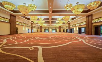 a large , empty conference room with a carpeted floor and chandeliers hanging from the ceiling at The Westin Playa Bonita Panama