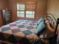 Three bedroom hide-a-way with spacious deck over looking Island Lake.