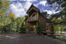 Lakefront secluded mult-family retreat with game room and two cabins.