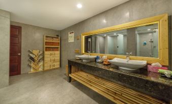 a modern bathroom with a large mirror , two sinks , and wooden shelves on the left side at Lake View Hotel