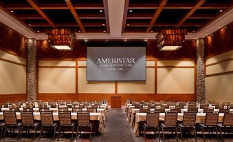 "a conference room with rows of chairs and tables , a large screen displaying the word "" ameristar "" above" at Ameristar Casino Black Hawk