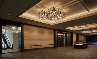 a spacious room with chandeliers and ceiling lighting, featuring an adjacent entrance at Hyatt Centric Kanazawa