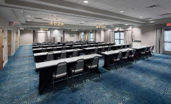 a large conference room with multiple rows of tables and chairs arranged for a meeting or event at Homewood Suites by Hilton Newburgh-Stewart Airport