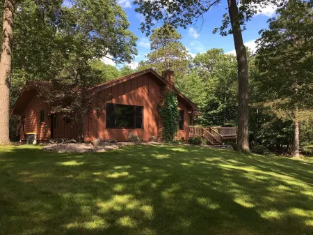 Escape to the Northwoods at this picturesque Sand Lake home