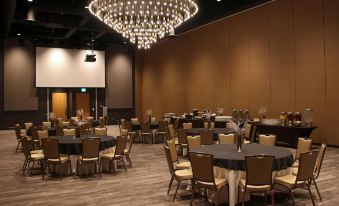 a large , empty banquet hall with multiple tables and chairs set up for a formal event at Angel of the Winds Casino Resort