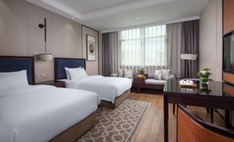 The modern bedroom features double beds and a spacious sitting area in the middle at Kasion Purey Hotel (Yiwu International Trade City store)