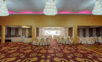 The ballroom is set up with tables and chairs in the middle for events or wedding receptions at Seagate Hotel