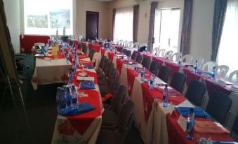 a conference room set up for a meeting , with tables and chairs arranged in rows at The Palace Hotel