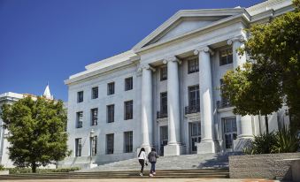 a large white building with columns and a set of stairs leading up to it at Graduate Berkeley
