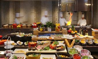 a kitchen with a variety of dishes and utensils , including bowls , forks , knives , and spoons at Hyatt Regency Naha, Okinawa