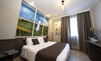 a large bed with a brown blanket is in a room with a window and a mural on the wall at Hotel Plaza
