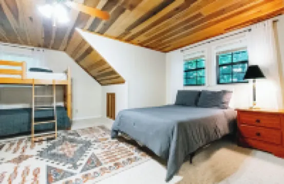 Luxurious cabin with fire pit, kayaks, and dock.