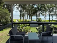 Large Lakefront House on Lake Macquarie with Kayaks, Kids Toys and Dog Door Hotels in Caves Beach