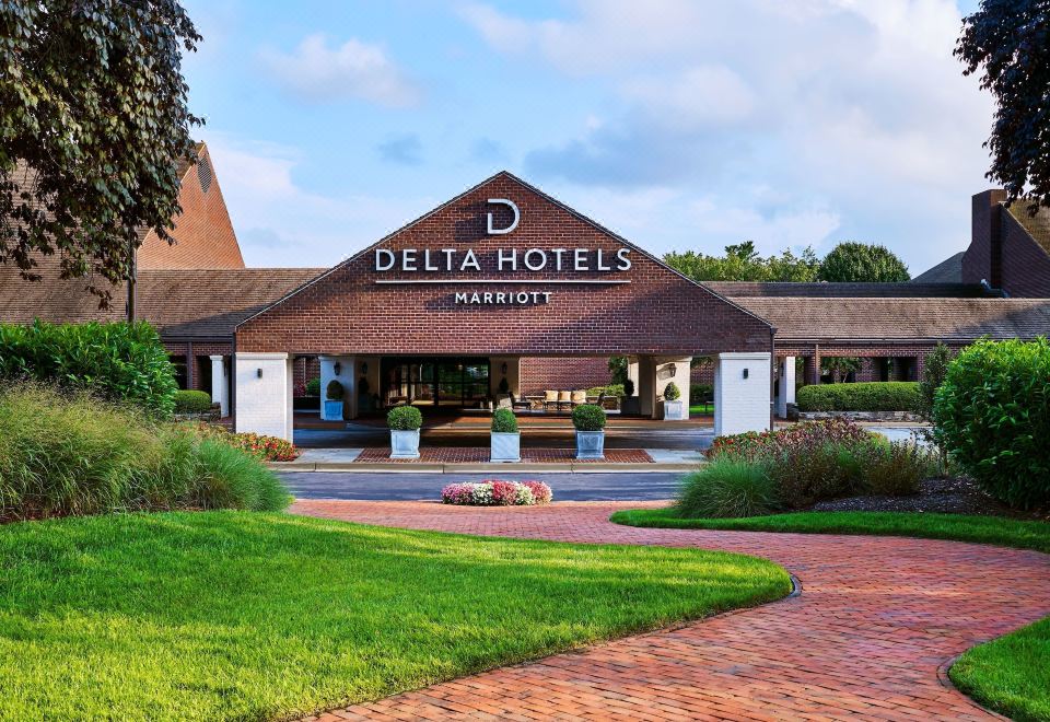 a large , modern hotel with a wooden roof and the name delta hotels marriott on top at Delta Hotels by Marriott Baltimore Hunt Valley