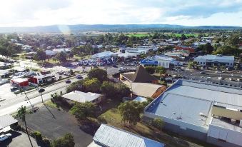 a bird 's eye view of a city with buildings , roads , and mountains in the background at Gatton Motel