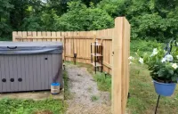 Charming 2-bedroom apartment with outdoor hot tub in rural area, private yard.
