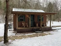 Peaceful cabin in secluded mountain spot beside a picturesque creek